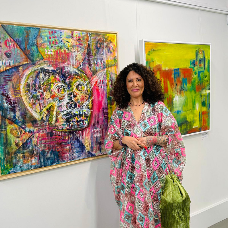 Artist Louise Duggan stood next to the painting Tough