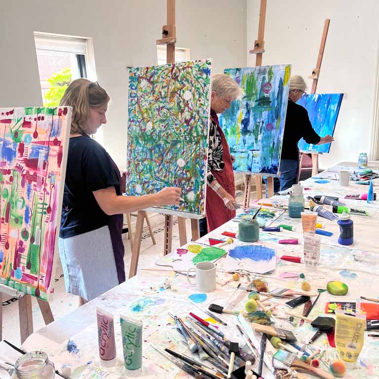 Participants painting during an abstract painting and mixed media workshop in Chichester